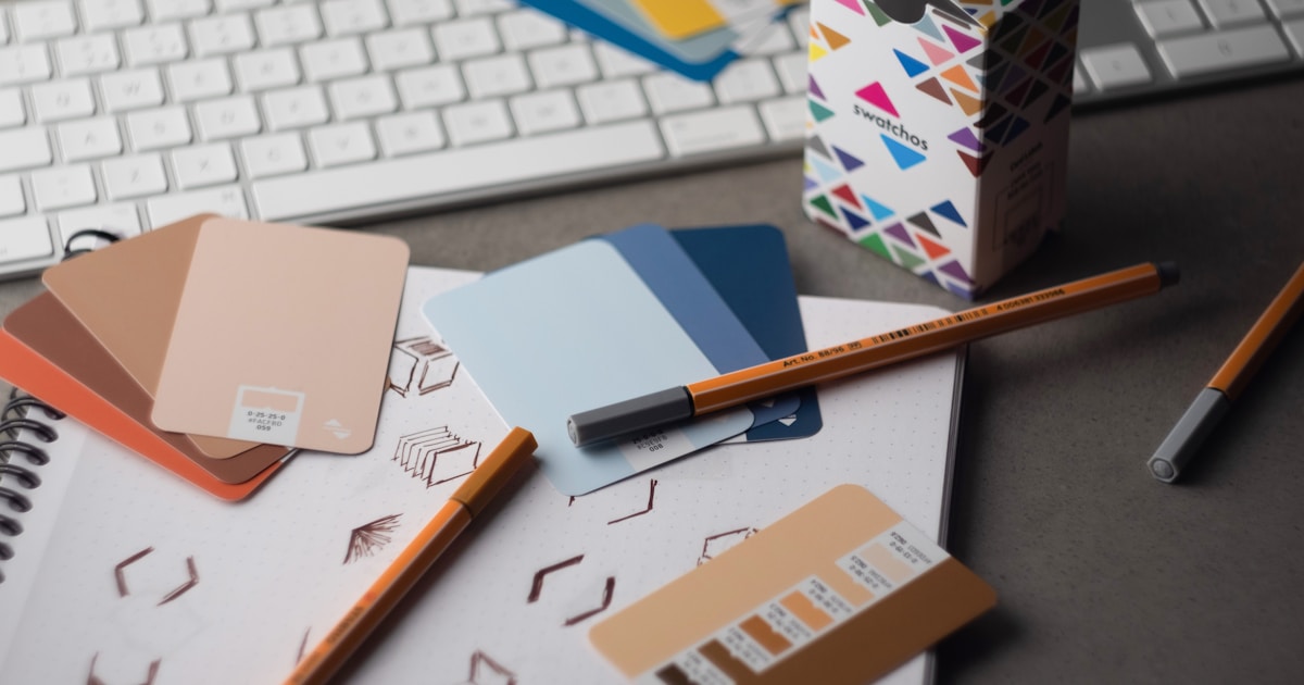 Graphic designer workspace with color swatches and sketches